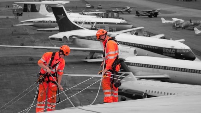 Rappel rope access technician cleaning the roof and external building faces