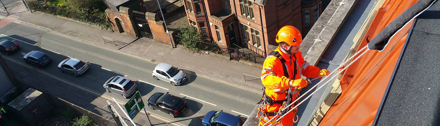 Rope Access technician undertaking cladding painting works