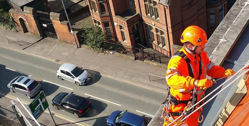 Rope Access technician undertaking cladding painting works
