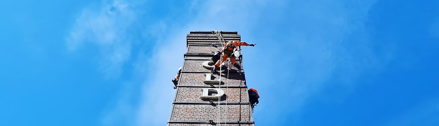 Rappel team working on a chimney stack repointing brickwork