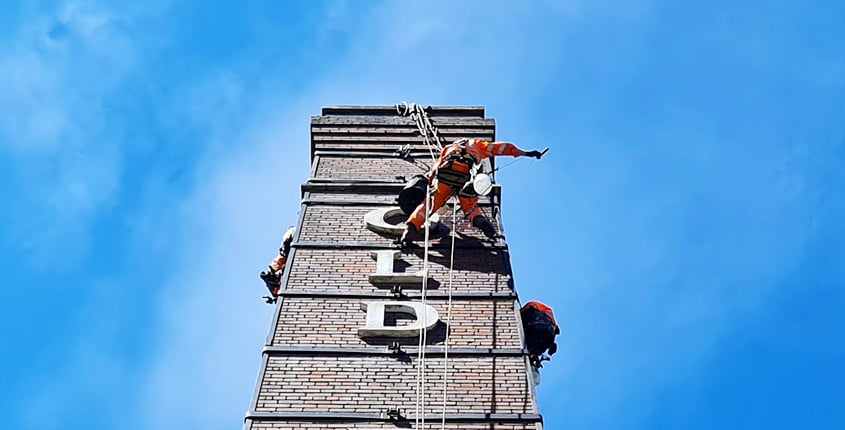 Rappel team working on a chimney stack repointing brickwork