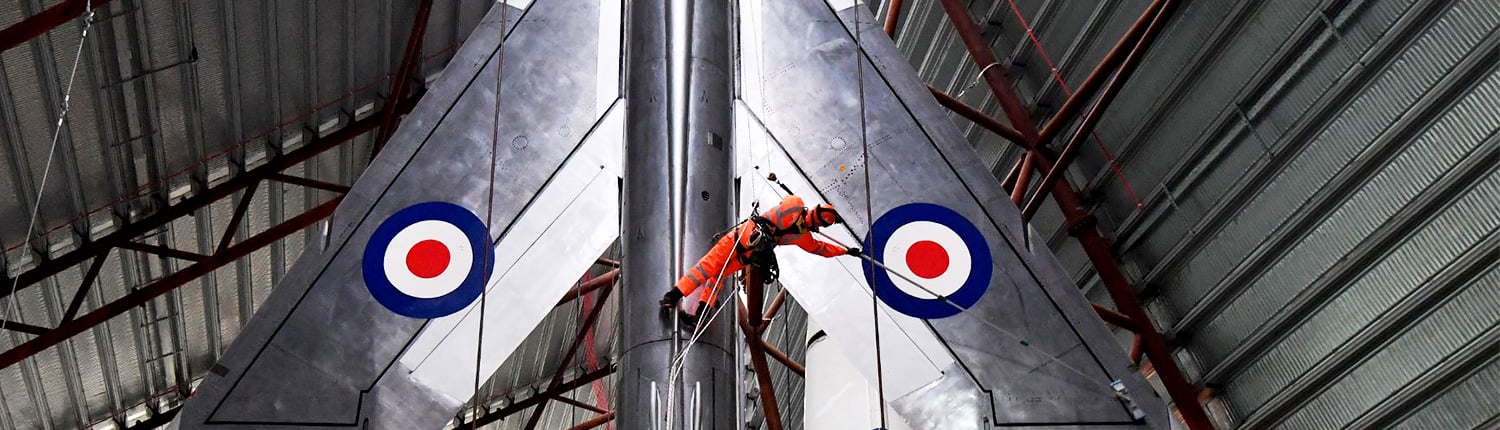Rappel Rope Access team cleaning jet fighter plane at RAF Cosford Museum