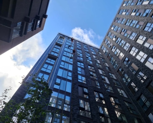 Building envelope and façade specialists carrying out rope access inspection works on a high-rise building